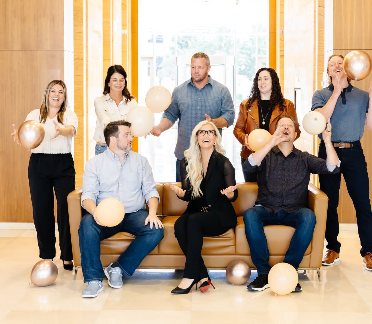 The Mortgage Nerd team laughing together on a couch